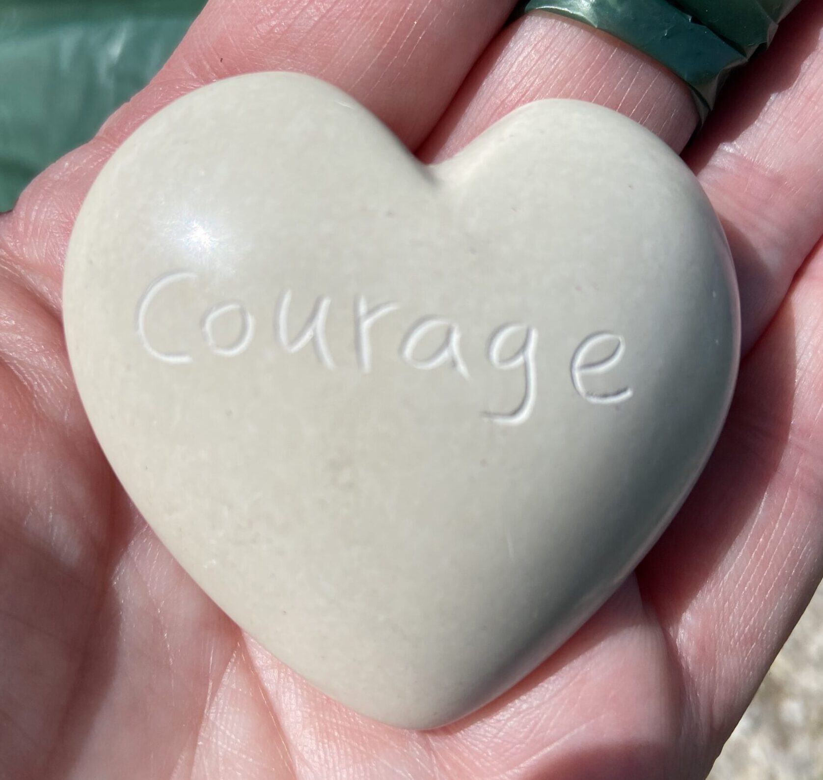 Heart-shaped stone with engraved "Courage"
